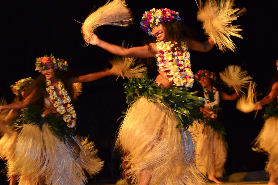 A group of female dancers dressed in traditional Pacific Island attire