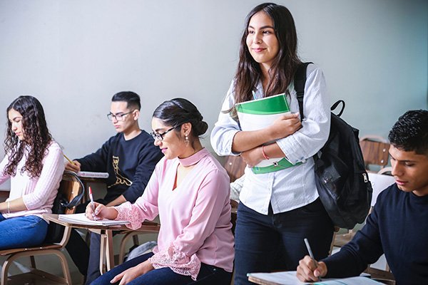 Student looking for a seat in a classroom