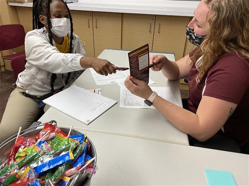 A Financial Wellness Collaborative worker and a student talking.