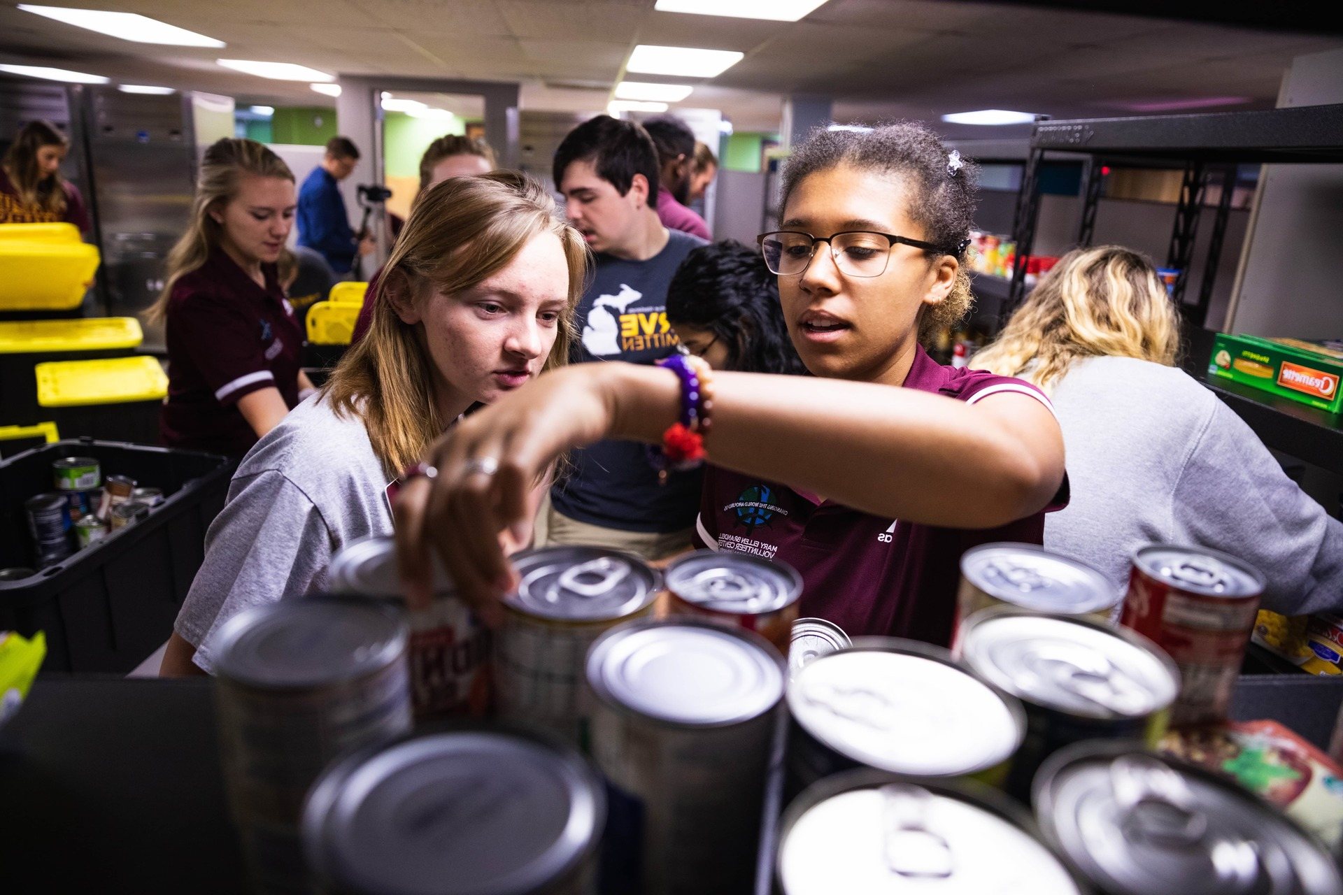 A group of student volunteers stocking the student food pantry.