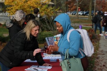 Student in conversation with Mt. Pleasant City clerk about registering to vote