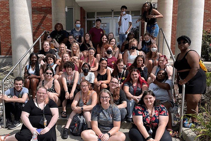 Group shot of Public Service Residential College students sitting outside on stairs