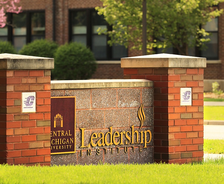 A brick sign reading "Leadership Institute" that sits outside of Powers Hall on the CMU campus