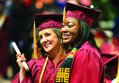 Students smiling at commencement ceremony