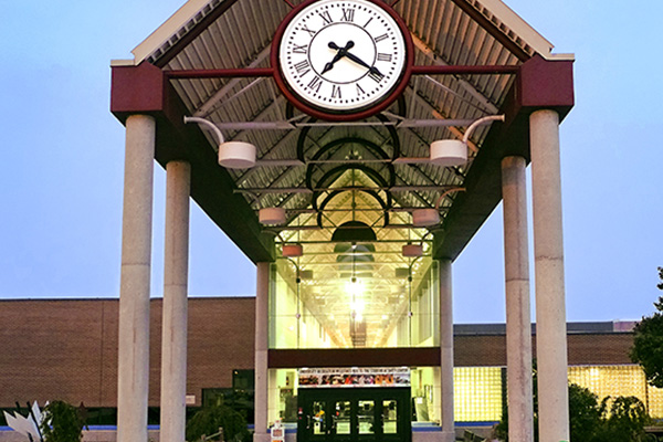 Front view of the Student Activity Center showing clock, archway and lobby