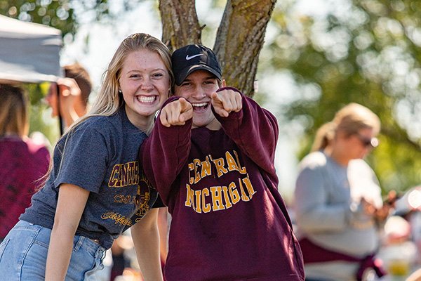 Students having fun at football tailgate event.