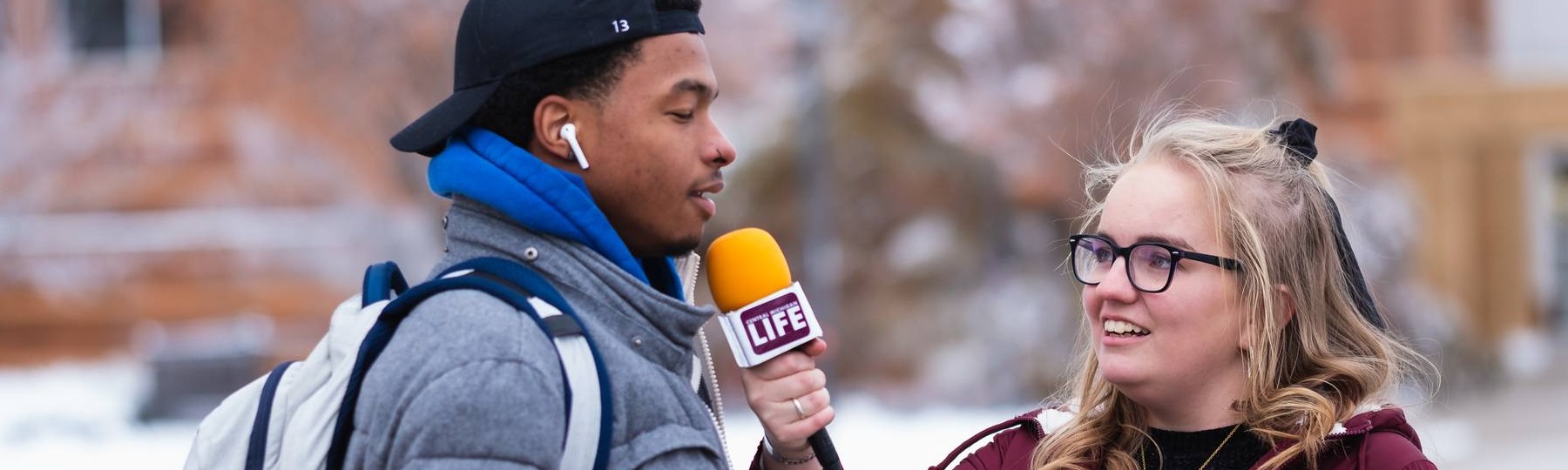 CM-Life's Alanna Sparks interviews a student on campus during the winter.