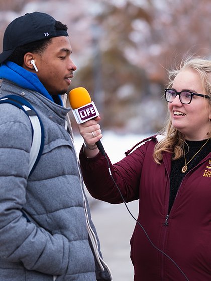 CM-Life's Alanna Sparks interviews a student on campus during the winter.