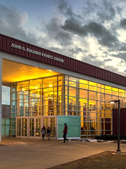 Kulhavi Events Center with lights on at night.