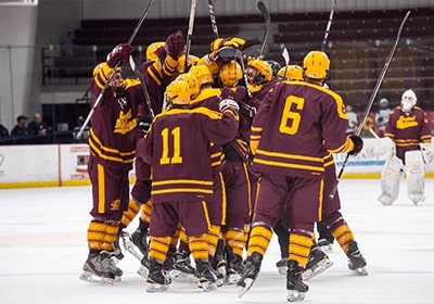 CMU Club Hockey team celebrating on the ice.