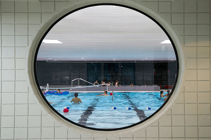 View of the pool at the Student Activity Center (SAC) through a side window