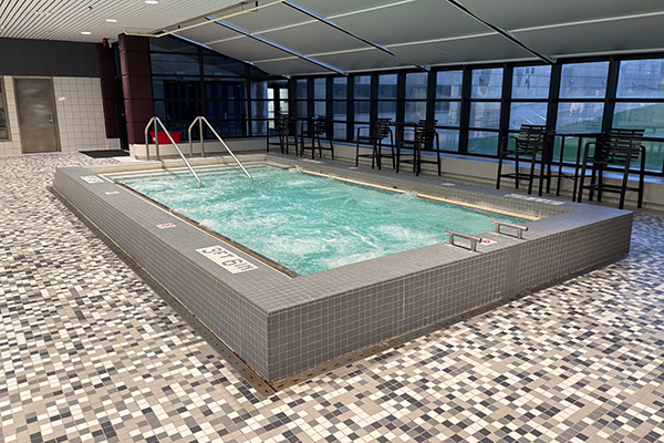 Image of the Student Activity Center spa with the jets on and agitating the water.