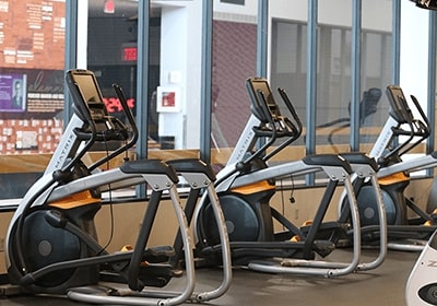 Elliptical equipment facing windows.