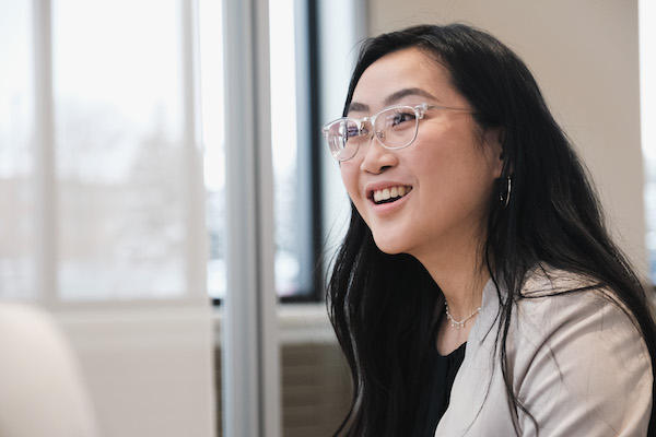 student smiling in mid conversation in professional dress