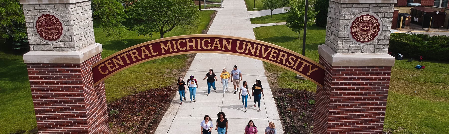 Students walking through CMU gateway
