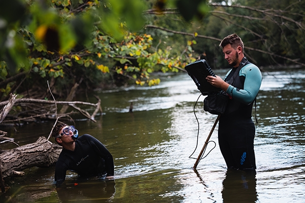 Two students doing research in the Chippewa River.