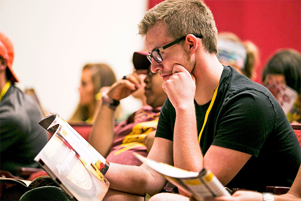 CMU student reading a publication