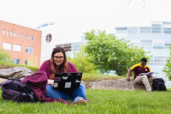 Students reading on the campus lawn