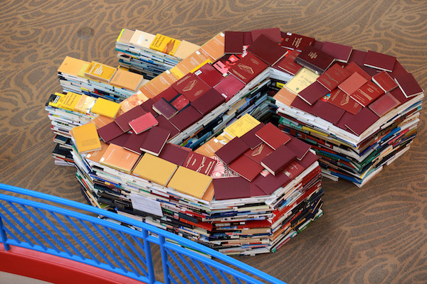 Maroon and gold books stacked into the shape of the Action C in Park Library.