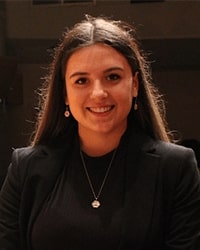 Allya Ankoviak wears a black jacket and smiles for a staff photo.