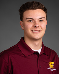 Evan Borr wears a CMU polo and smiles for a staff photo.