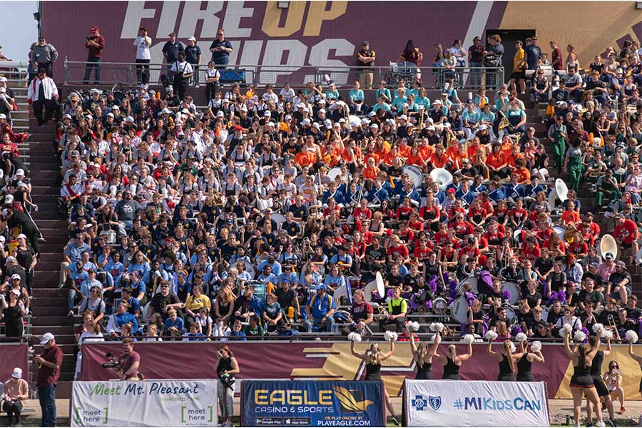 Photo of 2023 Band Day participants cheering in the stands for the CMU football team