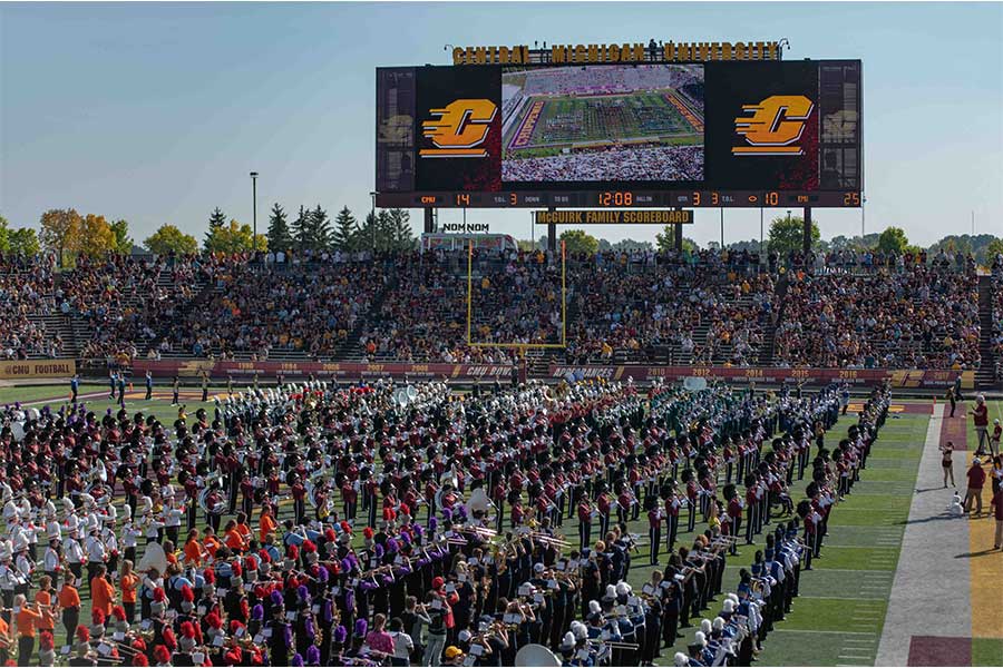 Football fans watching the Marching Chippewas and local bands in their halftime performance