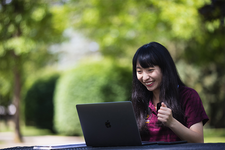 student at desk with laptop