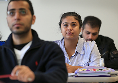 Three students sitting in a classroom