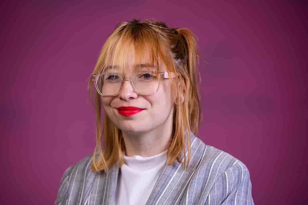 Professional headshot of Alyxczia Thurlow wearing a blue and white striped blazer with white shirt while looking at the camera.
