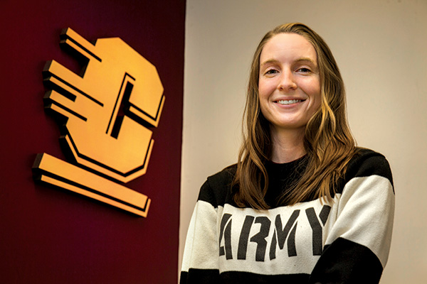 Army affiliated female student poses for camera