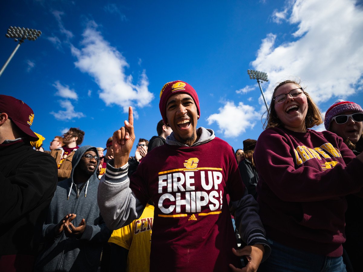 students cheering at football game