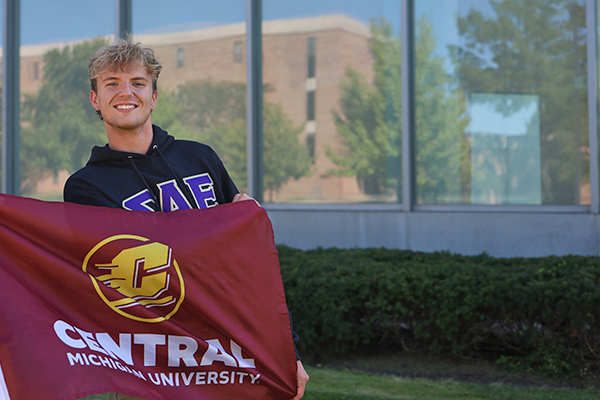An admitted student holds the CMU flag.