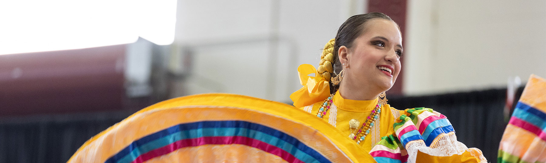 a female student dancing at the international student expo