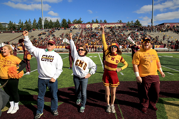 Alumni and friends cheer on the Central Michigan University Chippewa's during a home football game