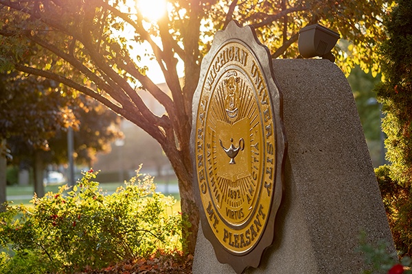University seal at sunrise