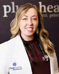 A woman with long light brown hair wears a white lab coat with a stethoscope around her neck.