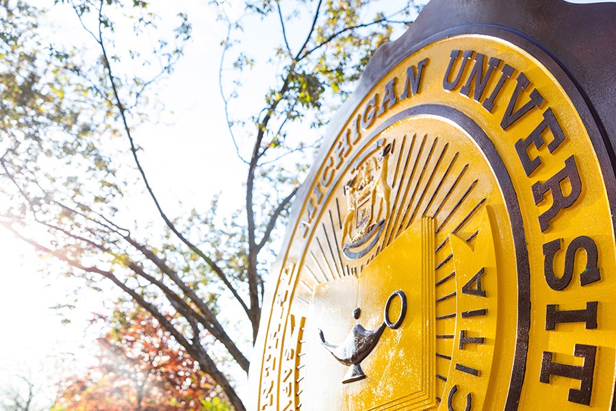 Central Michigan University seal in front of Warriner Hall