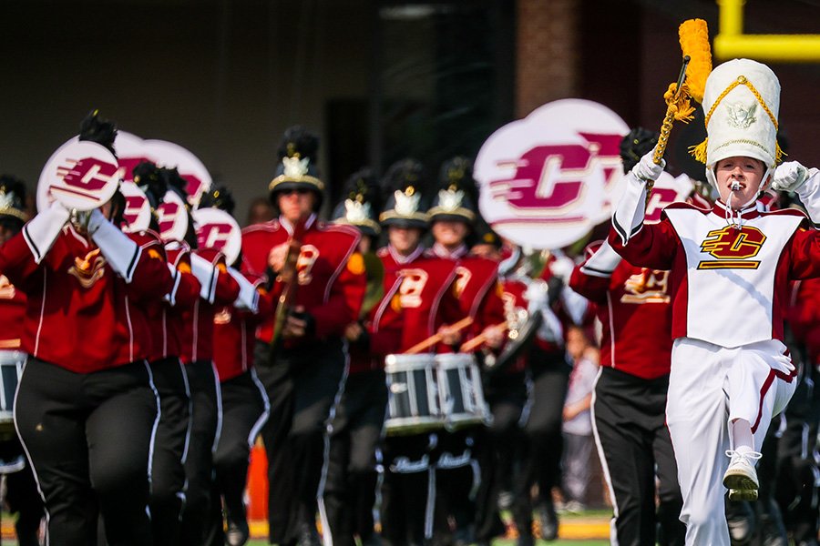 The Central Michigan University marching band marching on the football field.