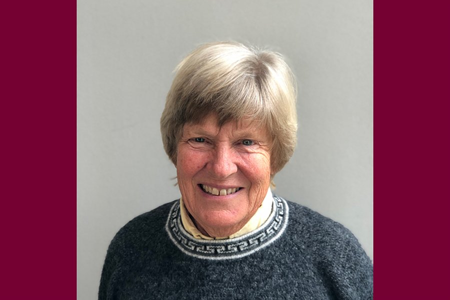 A headshot of Dr. P. Dee Boersma in a blue sweater against a gray background.