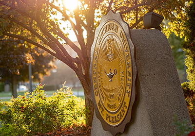 The statue of the Central Michigan University seal on a sunny day.