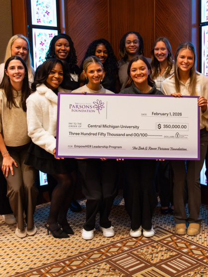 A group of women holding a large check.