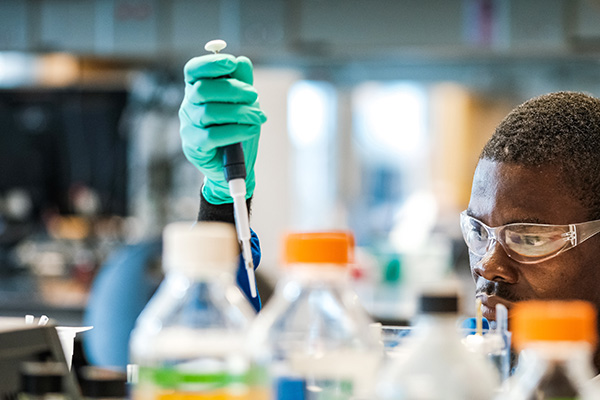 A Central Michigan University grad student working in a lab