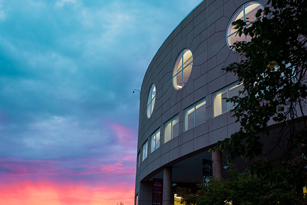 A picture of Park Library with a pink, purple, and blue sky.