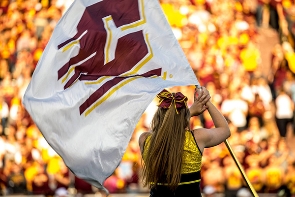 Central Michigan University cheerleader waving a giant