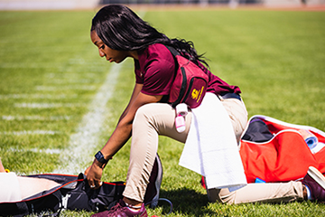 Athletic trainer on a football field.