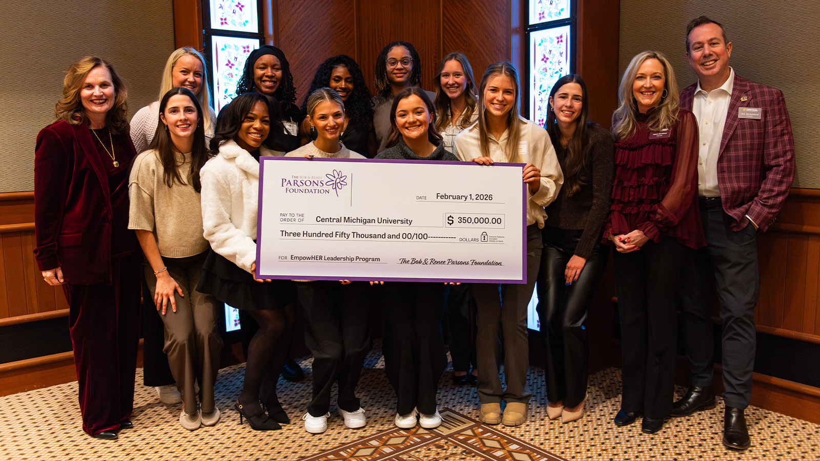 A group of people holding a large check.