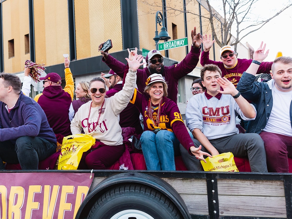 Alumni sit on a float during the 2021 homecoming parade.