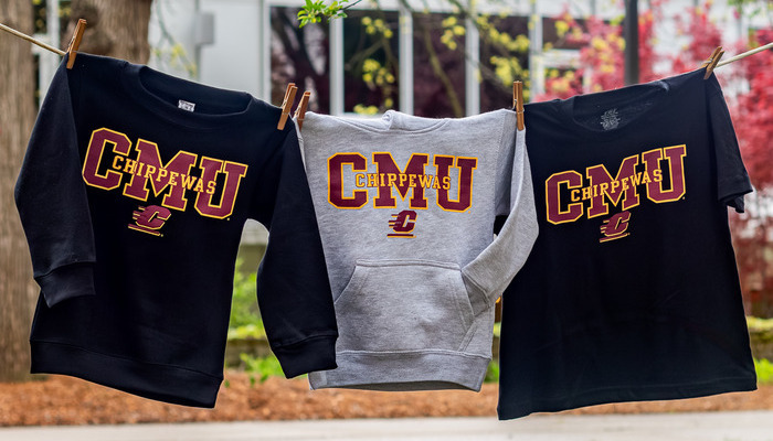 Three CMU clothing items, each saying CMU Chippewas with the Action C, hanging on a clothesline outdoors.