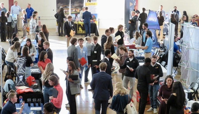 alumni_recruit_700x400 A CMU career fair inside Finch Fieldhouse with numerous students and recruiters at tables.